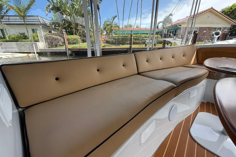Slide: The Image of Luxurious seating on 2021 Duffy Bay Island 22 boat, featuring tan cushions and elegant wood flooring. - 11