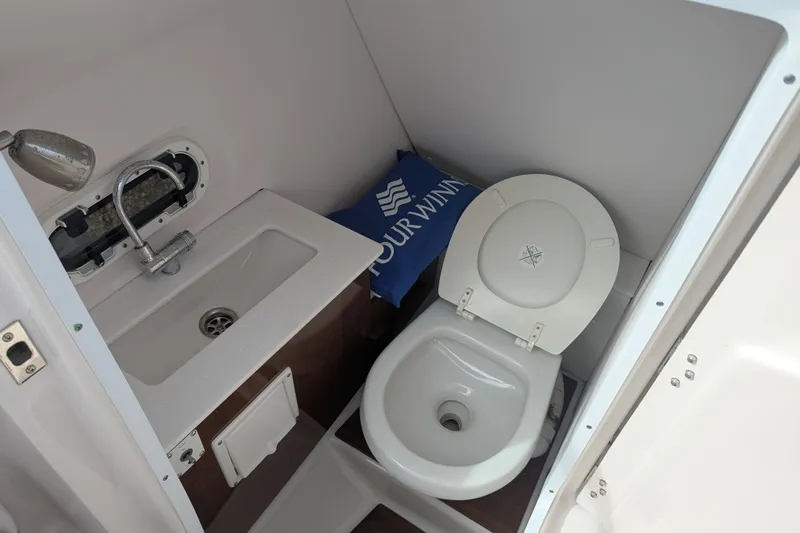 Slide: The Image of 2017 Four Winns HD240 boat bathroom with sink and toilet. - 12
