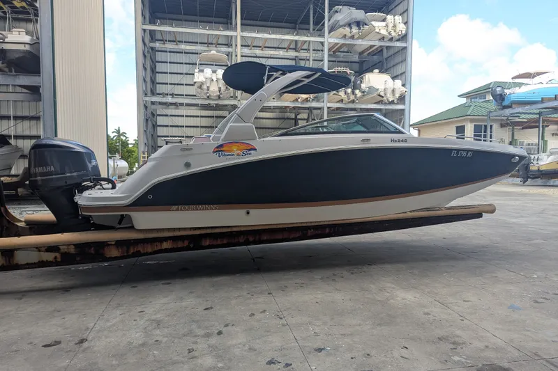 Slide: The Image of 2017 Four Winns HD240 boat with Yamaha engine in storage facility. - 5