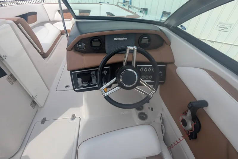 Slide: The Image of 2017 Four Winns HD240 boat interior with steering wheel and control panel. - 7