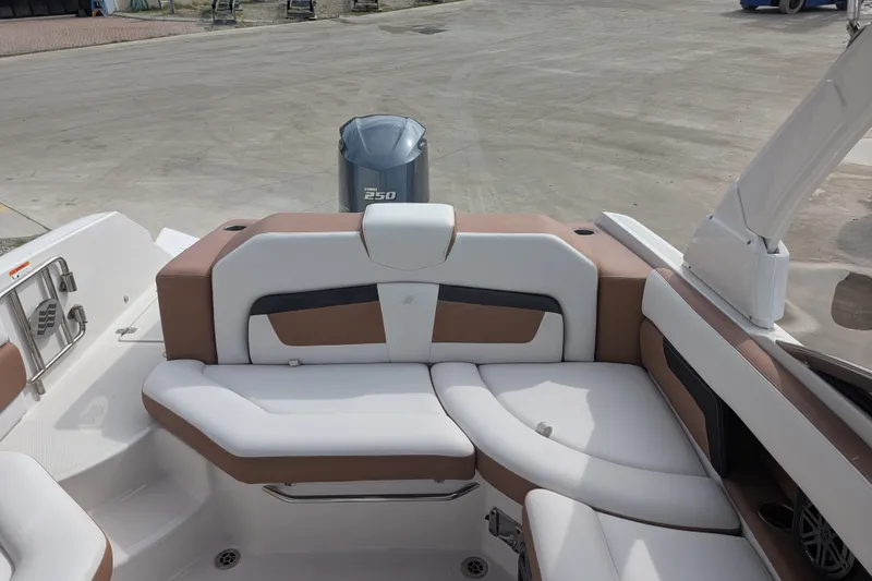 Slide: The Image of 2017 Four Winns HD240 boat interior with white and brown seating, Yamaha 250 engine visible. - 11