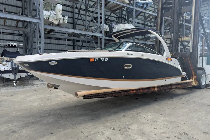 Slide: The Image of 2017 Four Winns HD240 boat on a forklift in a storage facility. - 4