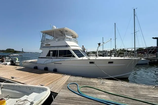 Slide: The Image of 1987 Fortier 40 yacht docked at marina under clear blue sky. - 6
