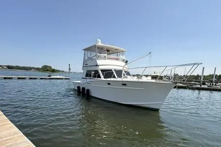 Slide: The Image of 1987 Fortier 40 boat docked on calm water under clear blue sky. - 4