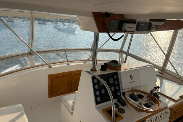 Slide: The Image of Cockpit view of a 1987 Fortier 40 boat with steering wheel and control panel. - 8