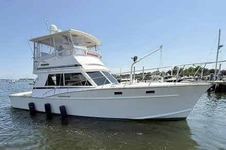 Slide: The Image of 1987 Fortier 40 boat docked in a marina under clear skies. - 3