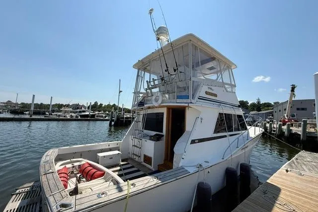 Slide: The Image of 1987 Fortier 40 boat docked at marina under clear blue sky. - 5