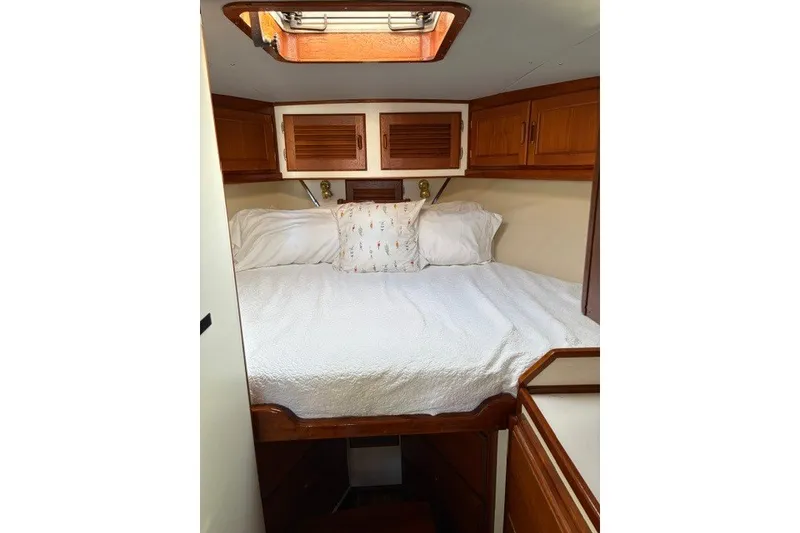 Slide: The Image of Cozy cabin interior of 1987 Fortier 40 boat with wooden accents and bedding. - 15