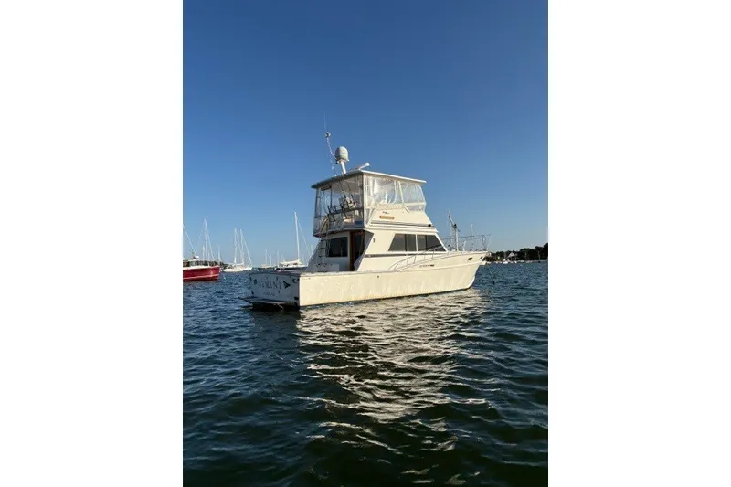 Slide: The Image of 1987 Fortier 40 boat on calm water under clear blue sky. - 2