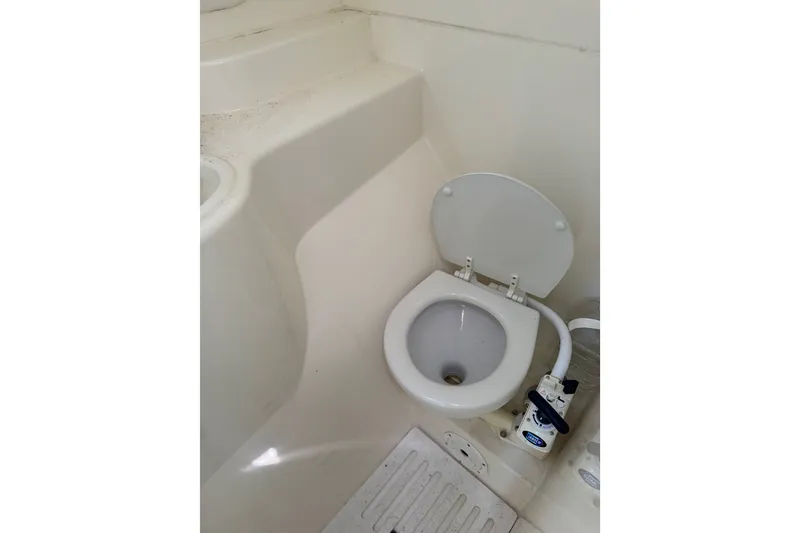 Slide: The Image of Compact marine toilet in a 2004 Corsair 36 sailboat bathroom. - 5