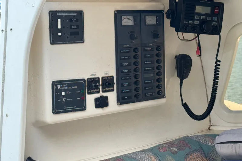 Slide: The Image of Control panel of a 2004 Corsair 36 boat with radio and switches. - 7