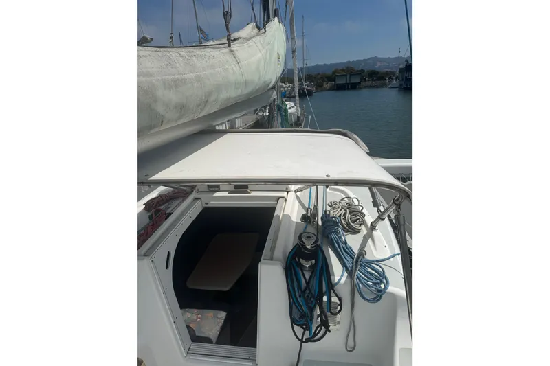 Slide: The Image of 2004 Corsair 36 sailboat deck with ropes and open cabin entrance. - 10
