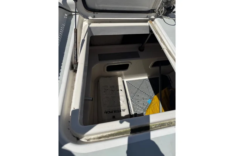 Slide: The Image of Open hatch of 2004 Corsair 36 sailboat, showing storage compartment with equipment. - 8