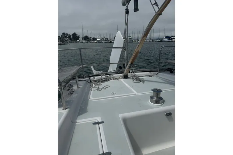 Slide: The Image of 2004 Corsair 36 sailboat deck with marina view, featuring rigging and winch. - 9