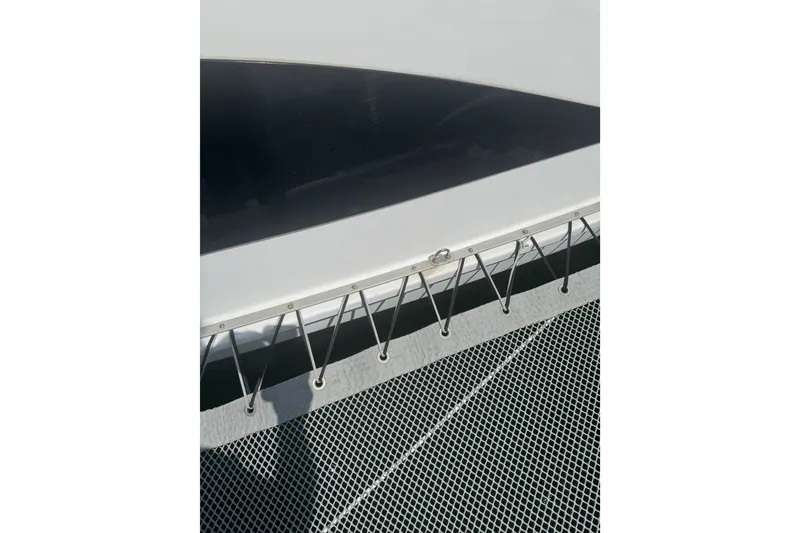 Slide: The Image of Close-up of 2004 Corsair 36 boat deck with netting and sleek design. - 12