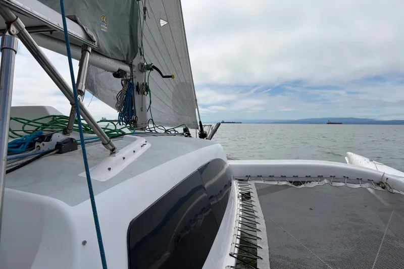 Slide: The Image of 2004 Corsair 36 sailboat on open water, featuring deck and sail details. - 16
