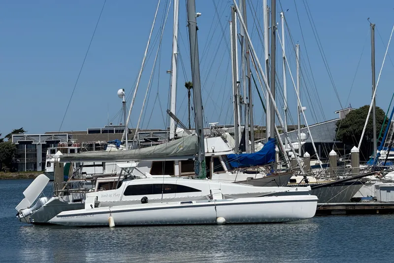 The Image of 2004 Corsair 36 sailboat docked at a marina with other vessels. - 1