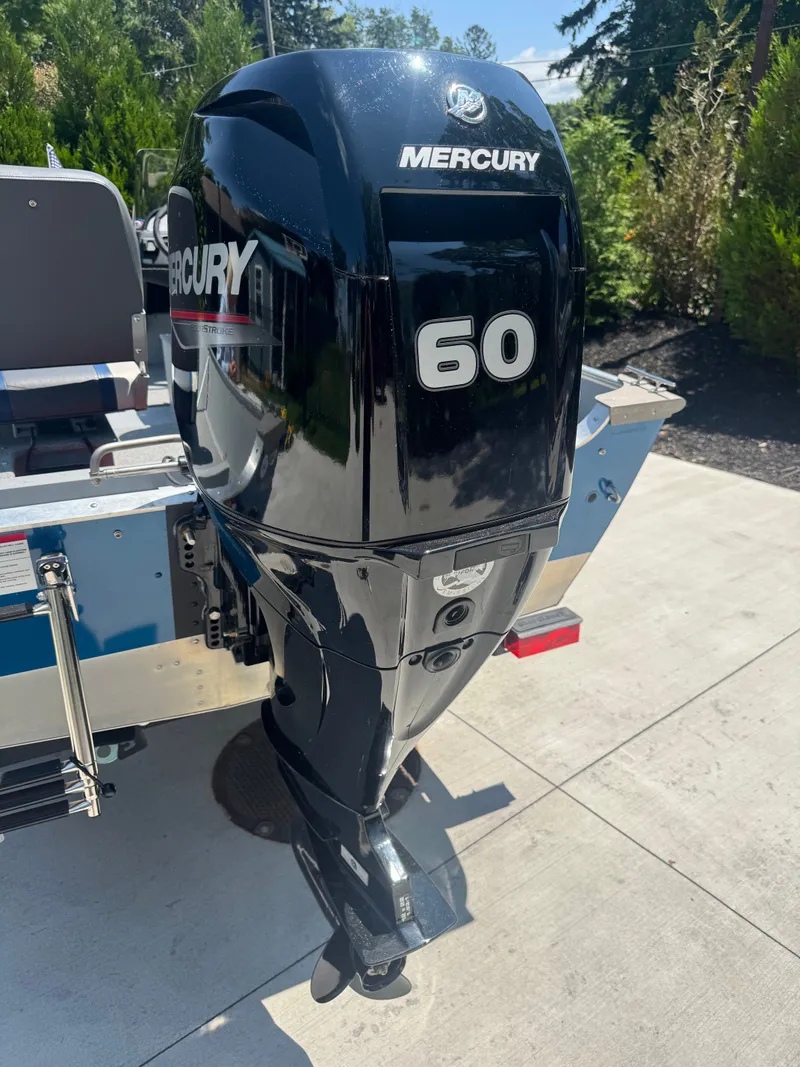Slide: The Image of A Mercury 60 outboard motor is mounted on a Lund SSV-18 boat. - 7