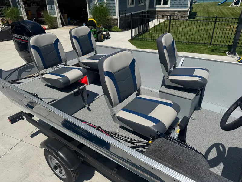 Slide: The Image of The image shows a 2025 Lund SSV-18 boat with four cushioned seats. - 5