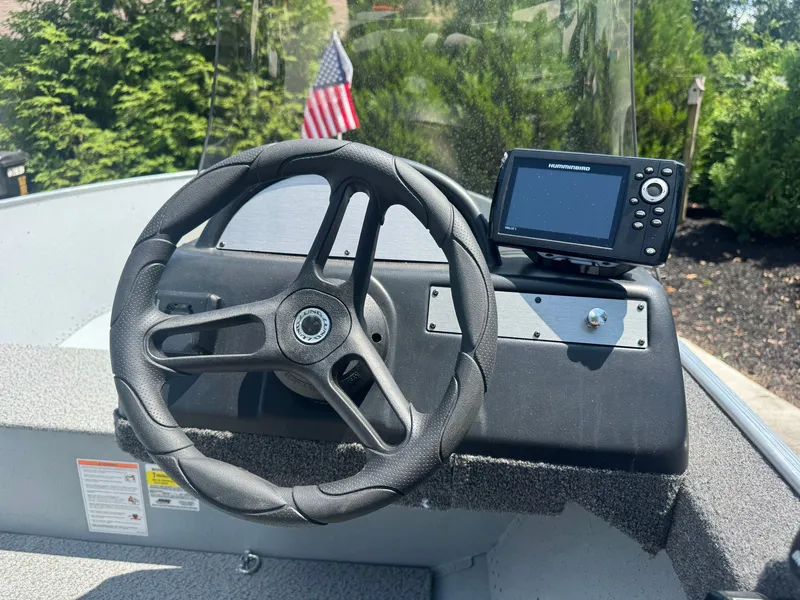 Slide: The Image of The image shows the helm of a 2025 Lund SSV-18 boat with a navigation device. - 4