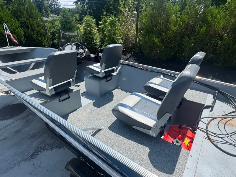 Slide: The Image of The image shows a 2025 Lund SSV-18 boat with four gray seats and a steering console. - 2