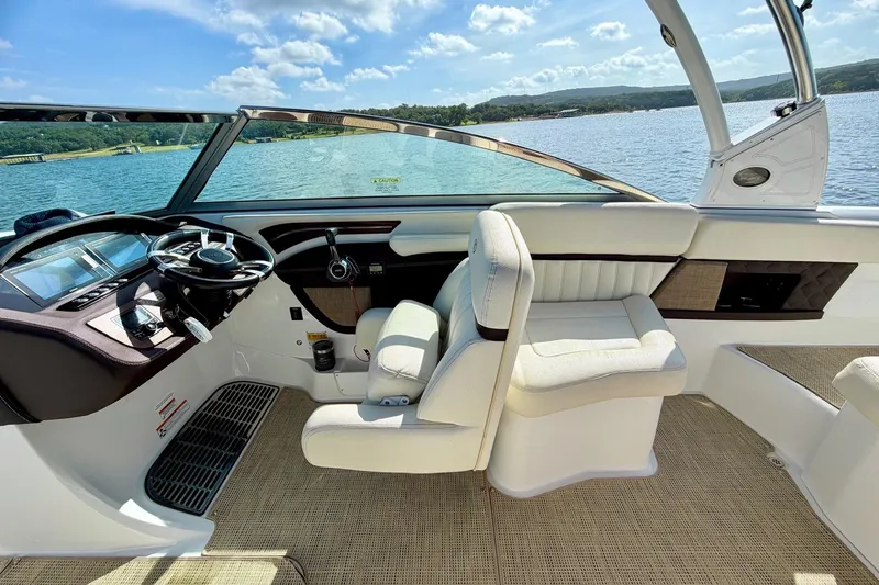 Slide: The Image of Interior of a 2017 Cobalt A25 boat with luxurious seating and steering wheel. - 17