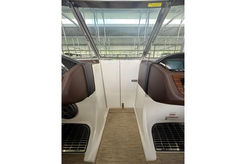 Slide: The Image of Interior view of a 2017 Cobalt A25 boat cockpit with brown accents. - 43