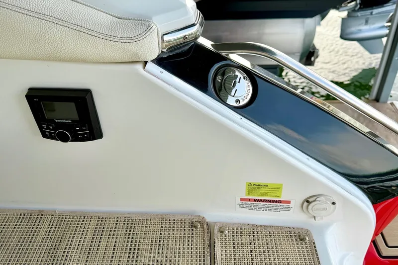 Slide: The Image of 2017 Cobalt A25 boat interior with control panel and fuel cap. - 33
