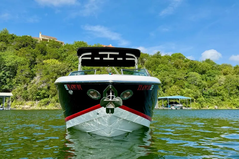 Slide: The Image of 2017 Cobalt A25 boat on a lake with lush green trees in the background. - 4