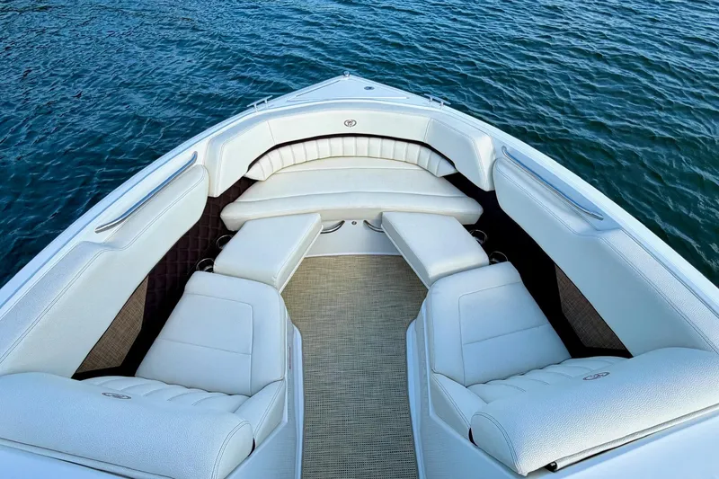 Slide: The Image of Luxurious 2017 Cobalt A25 boat interior with white seating, overlooking calm blue water. - 18