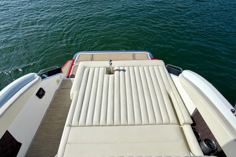 Slide: The Image of 2017 Cobalt A25 boat with spacious sun deck on calm water. - 11