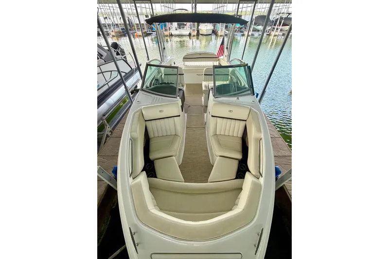 Slide: The Image of 2017 Cobalt A25 boat with beige seating, docked in a marina. - 46