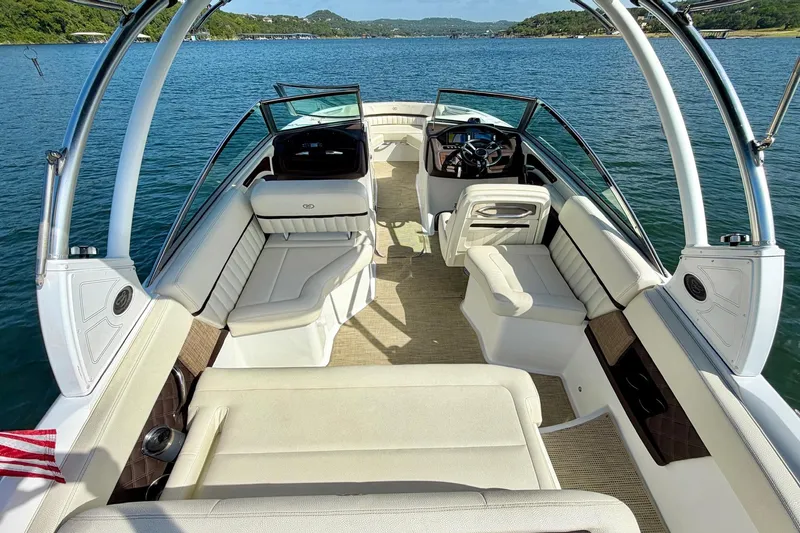 Slide: The Image of 2017 Cobalt A25 boat interior with luxurious seating on a serene lake. - 13