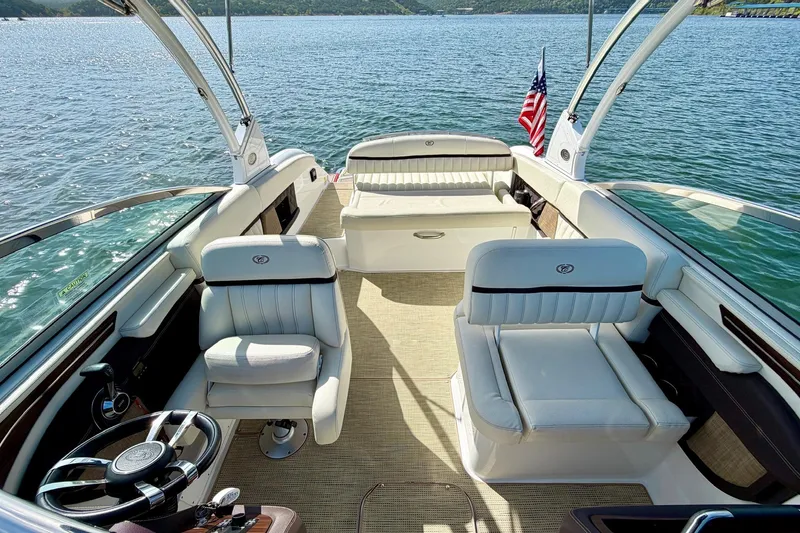 Slide: The Image of Luxurious 2017 Cobalt A25 boat interior with plush seating and scenic lake view. - 15