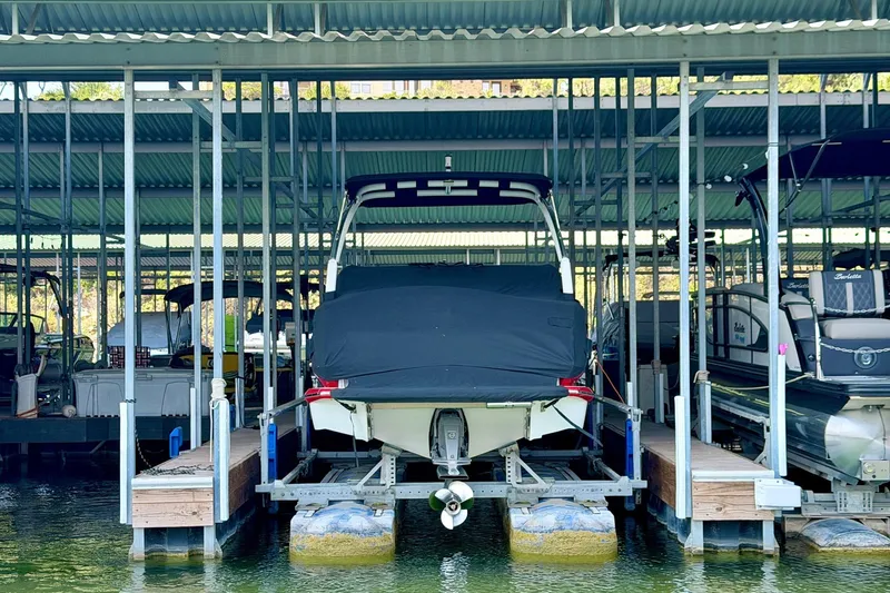 Slide: The Image of 2017 Cobalt A25 boat docked in a covered marina slip. - 29