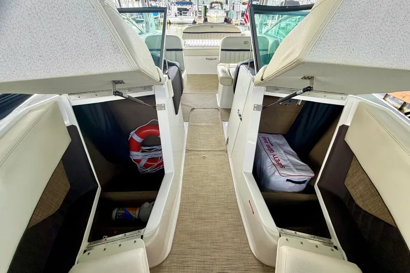 Slide: The Image of Interior of a 2017 Cobalt A25 boat with open storage compartments. - 44