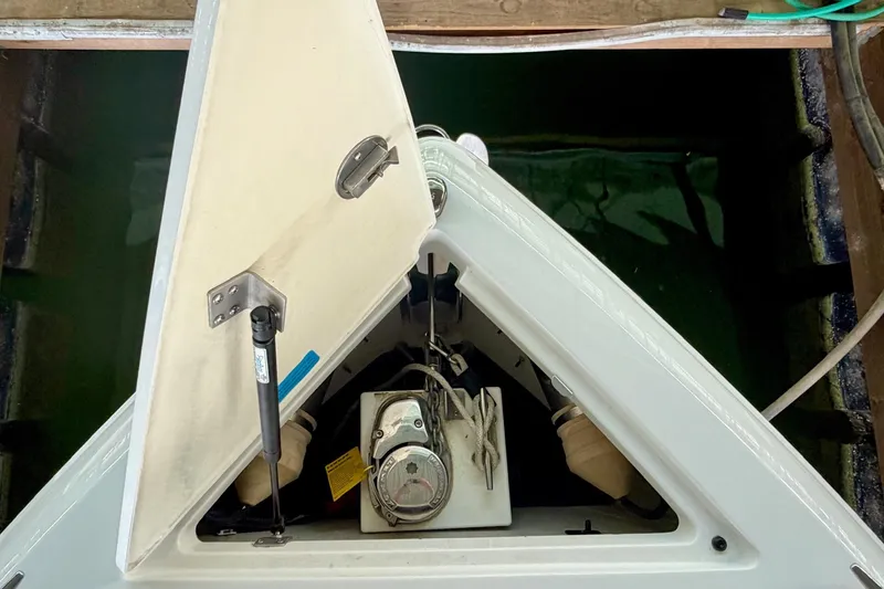 Slide: The Image of Open hatch of a 2017 Cobalt A25 boat, revealing internal components. - 45