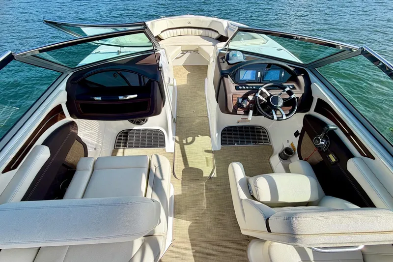 Slide: The Image of Luxurious interior of a 2017 Cobalt A25 boat with plush seating and modern dashboard. - 14