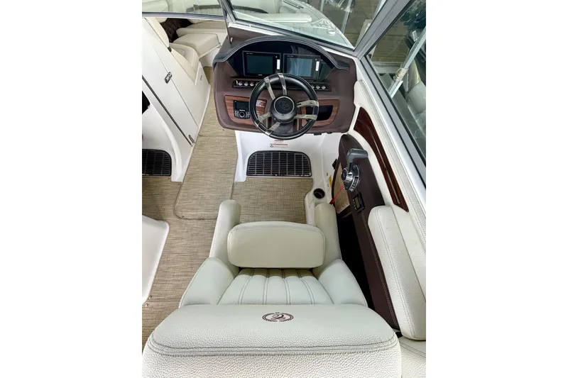 Slide: The Image of Interior view of 2017 Cobalt A25 boat cockpit with steering wheel and controls. - 39