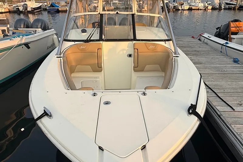 Slide: The Image of 2018 Scout 275 Dorado boat docked at marina, showcasing spacious seating and sleek design. - 3