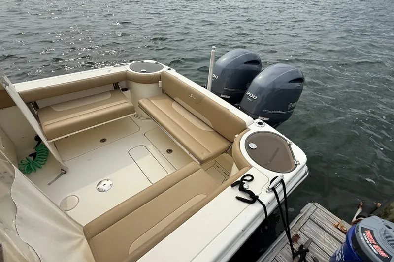 Slide: The Image of 2018 Scout 275 Dorado boat with twin Yamaha engines docked on water. - 10