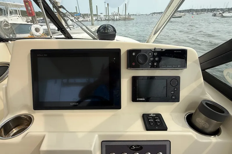 Slide: The Image of Control panel of a 2018 Scout 275 Dorado boat with Garmin and Yamaha displays. - 16