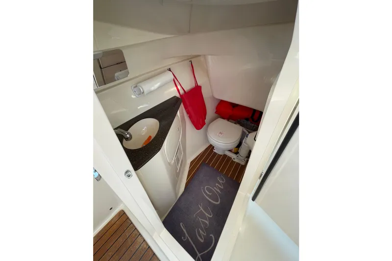 Slide: The Image of 2018 Scout 275 Dorado boat interior with sink, toilet, and wooden flooring. - 3