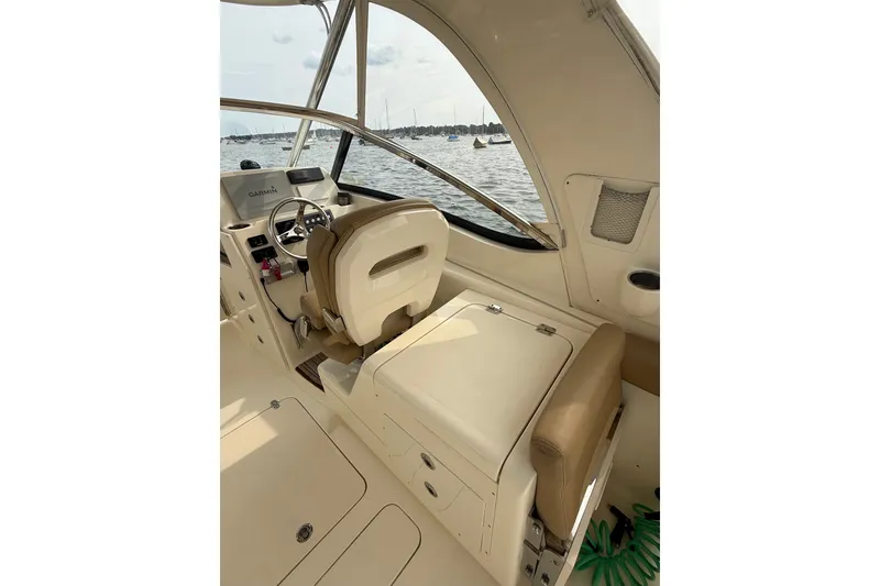 Slide: The Image of 2018 Scout 275 Dorado boat interior with helm, seating, and water view. - 21