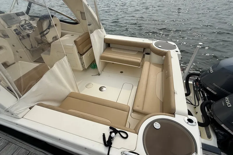 Slide: The Image of 2018 Scout 275 Dorado boat interior with beige seating and dual outboard motors. - 9
