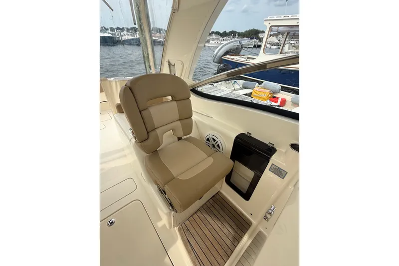 Slide: The Image of 2018 Scout 275 Dorado boat interior with tan seating and wood flooring. - 20