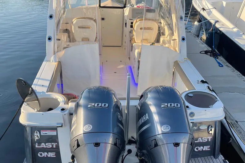 Slide: The Image of 2018 Scout 275 Dorado boat with twin Yamaha 200 engines docked at marina. - 2