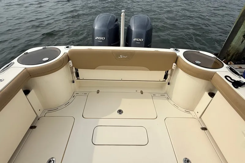 Slide: The Image of 2018 Scout 275 Dorado boat deck with twin Yamaha 200 engines on water. - 6