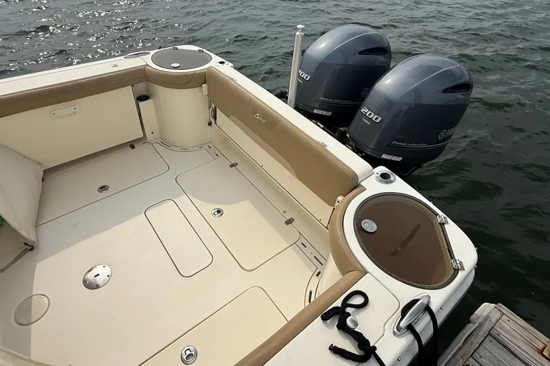 Slide: The Image of 2018 Scout 275 Dorado boat with twin Yamaha 200 engines docked by the water. - 7