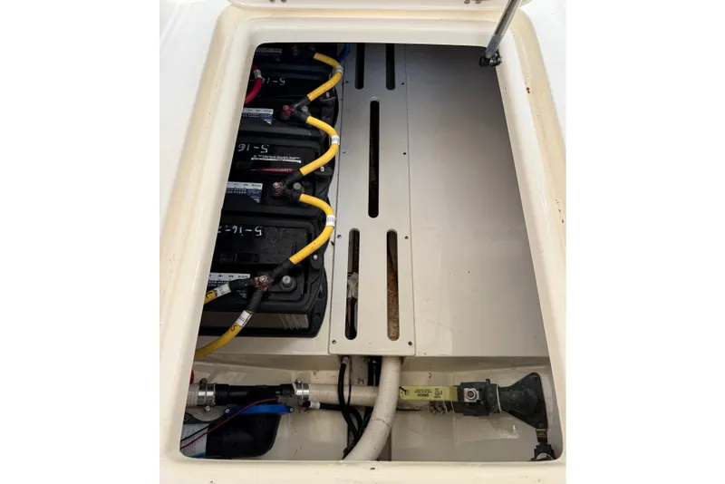 Slide: The Image of Battery compartment of a 2018 Scout 275 Dorado boat with wiring and components. - 23